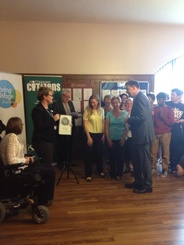 Dr Hugh Porter receiving his Living Wage accreditation.